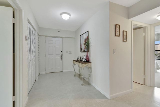 corridor featuring light tile patterned floors