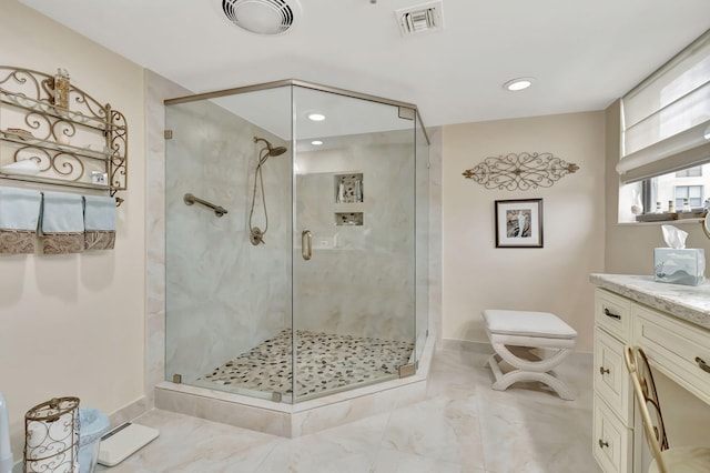 bathroom featuring walk in shower and vanity