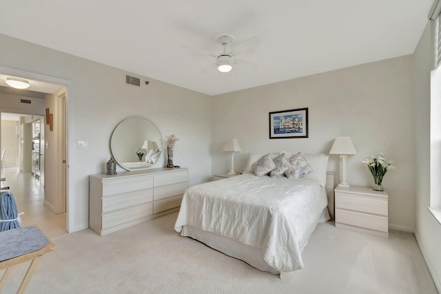 bedroom featuring light carpet and ceiling fan