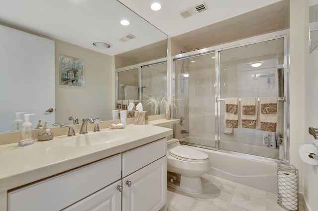 full bathroom with toilet, combined bath / shower with glass door, vanity, and tile patterned floors