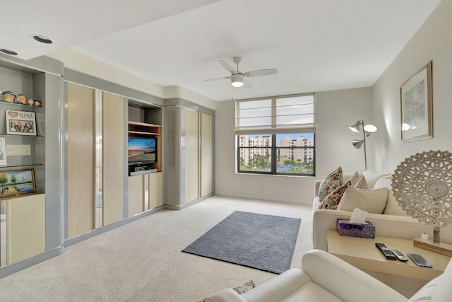 living room featuring ceiling fan and light colored carpet