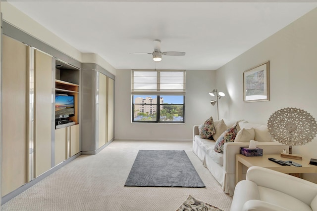 carpeted living room with ceiling fan