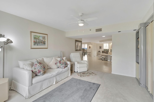 carpeted living room with ceiling fan