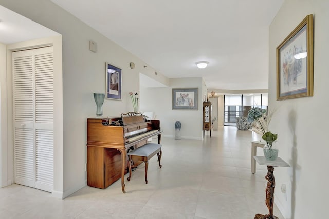 misc room with light tile patterned floors