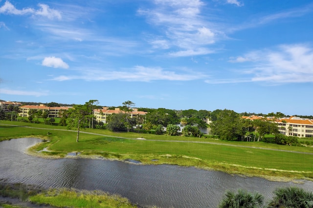 view of community with a water view and a lawn