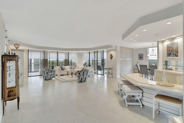 living room featuring a wealth of natural light and light tile patterned floors