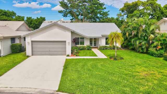 view of front of property featuring a front yard and a garage