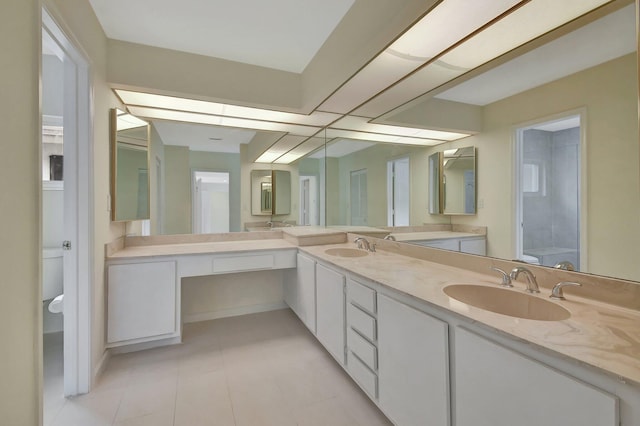 bathroom with vanity, a shower with shower door, toilet, and tile patterned floors