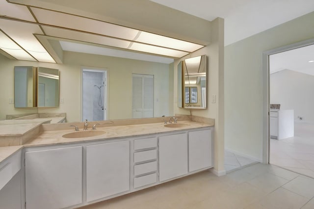 bathroom featuring vanity, walk in shower, and tile patterned flooring