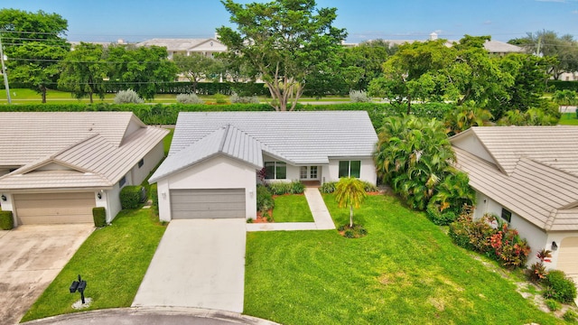 ranch-style house featuring a front lawn and a garage