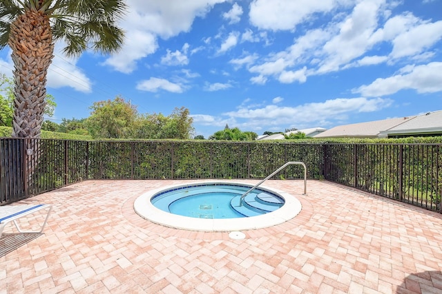 view of swimming pool featuring an in ground hot tub and a patio area