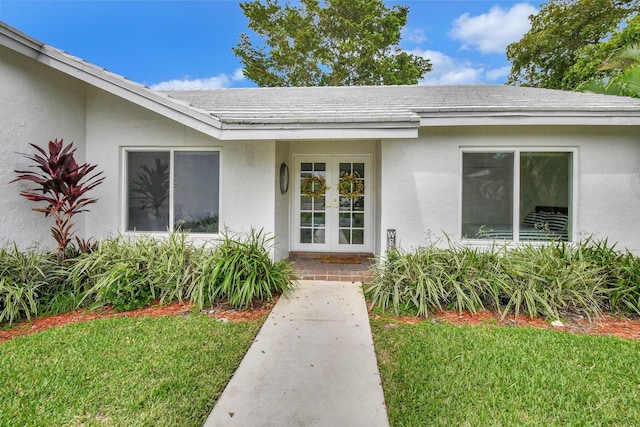 doorway to property featuring a lawn