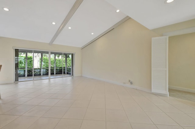 tiled empty room featuring beam ceiling and high vaulted ceiling