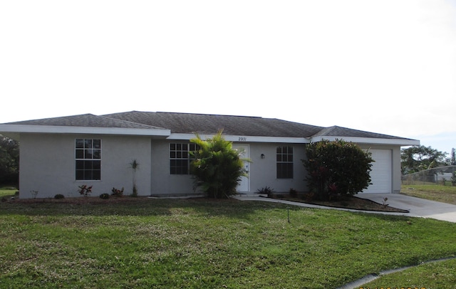 ranch-style home with a garage and a front lawn