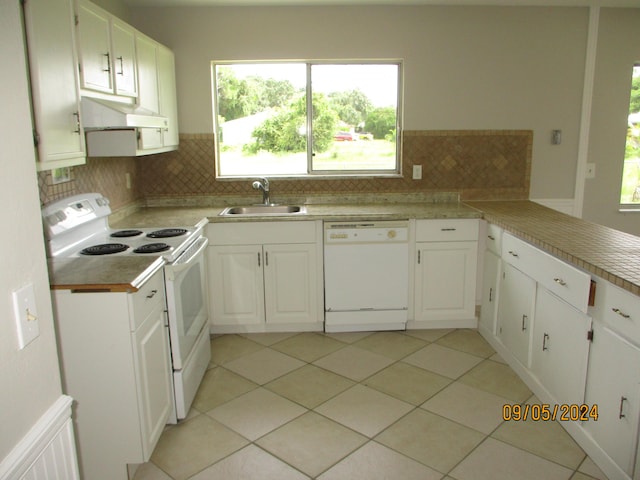 kitchen with sink, white appliances, and white cabinets