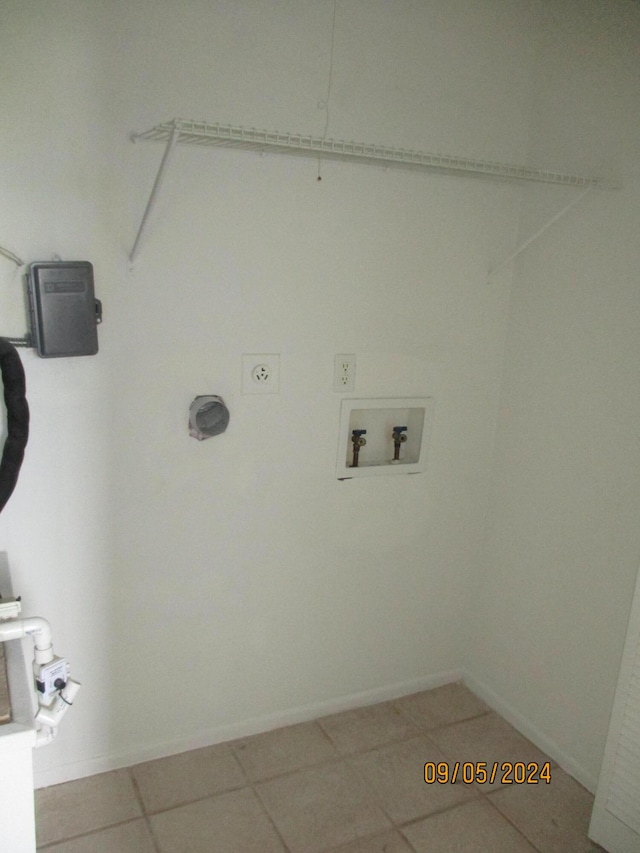 clothes washing area featuring tile patterned floors, hookup for a washing machine, and electric dryer hookup