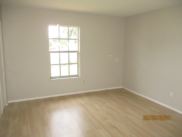 spare room with light hardwood / wood-style flooring