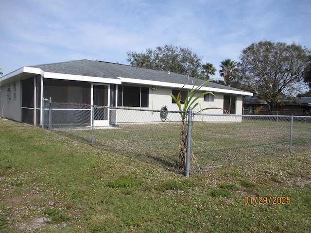 single story home with a sunroom and a front yard