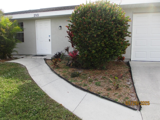 view of exterior entry with a garage