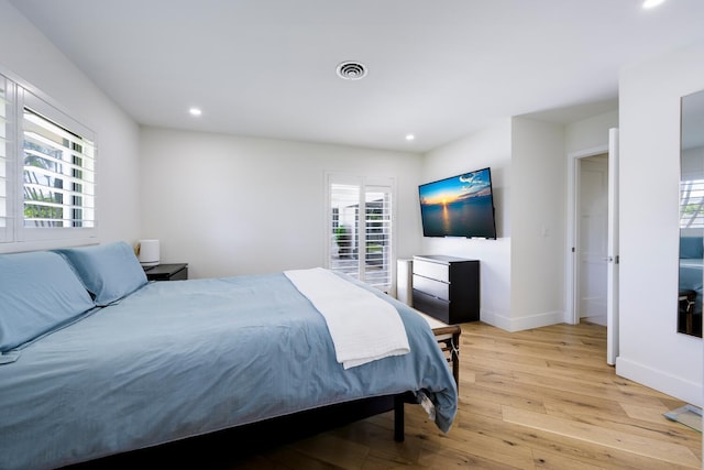 bedroom featuring multiple windows and light wood-type flooring