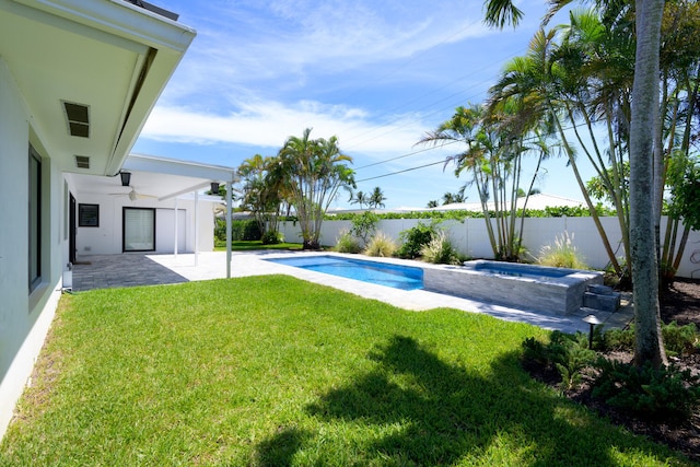 exterior space with a lawn, a patio area, an in ground hot tub, and ceiling fan