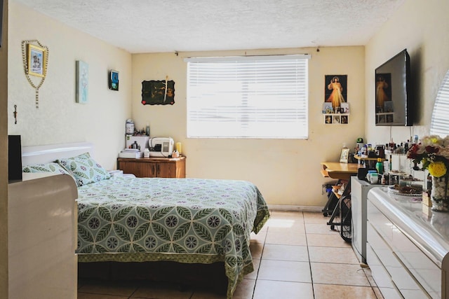 tiled bedroom featuring a textured ceiling