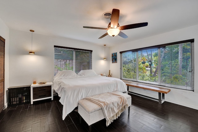 bedroom with ceiling fan and dark wood-type flooring