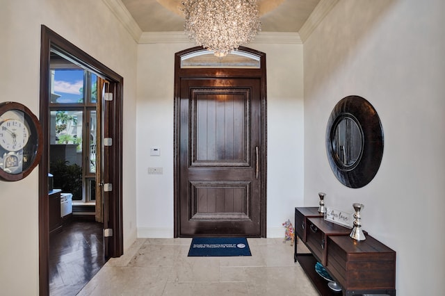 entryway featuring crown molding and a chandelier