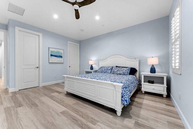 bedroom with ceiling fan and light hardwood / wood-style floors