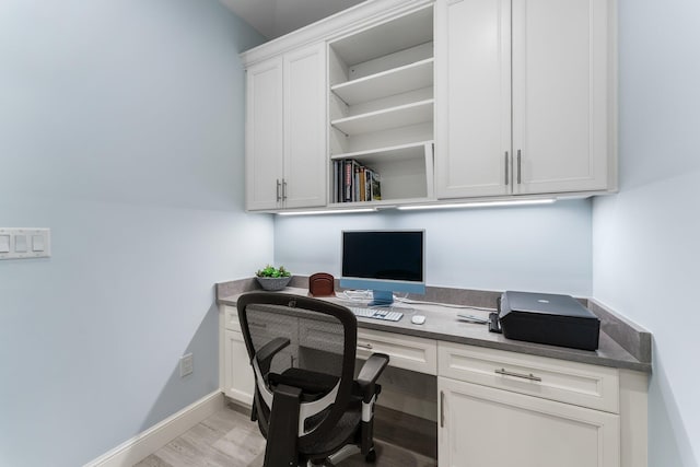 office area featuring built in desk and light hardwood / wood-style floors