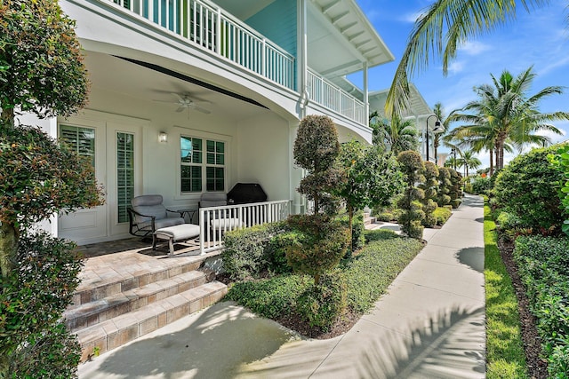 exterior space featuring ceiling fan and a balcony