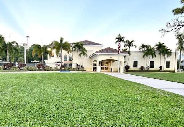 mediterranean / spanish-style home with a front lawn