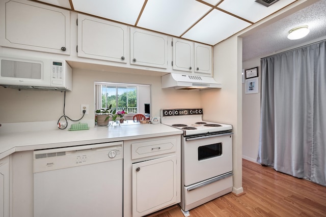 kitchen featuring white cabinets, white appliances, a textured ceiling, and light hardwood / wood-style flooring