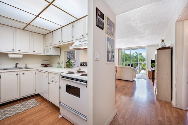 kitchen featuring sink, white appliances, white cabinetry, and light hardwood / wood-style floors