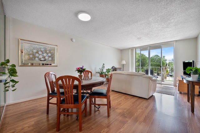 dining room featuring a textured ceiling and hardwood / wood-style floors