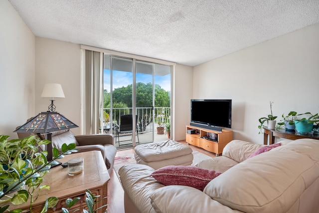 living room featuring a textured ceiling and floor to ceiling windows