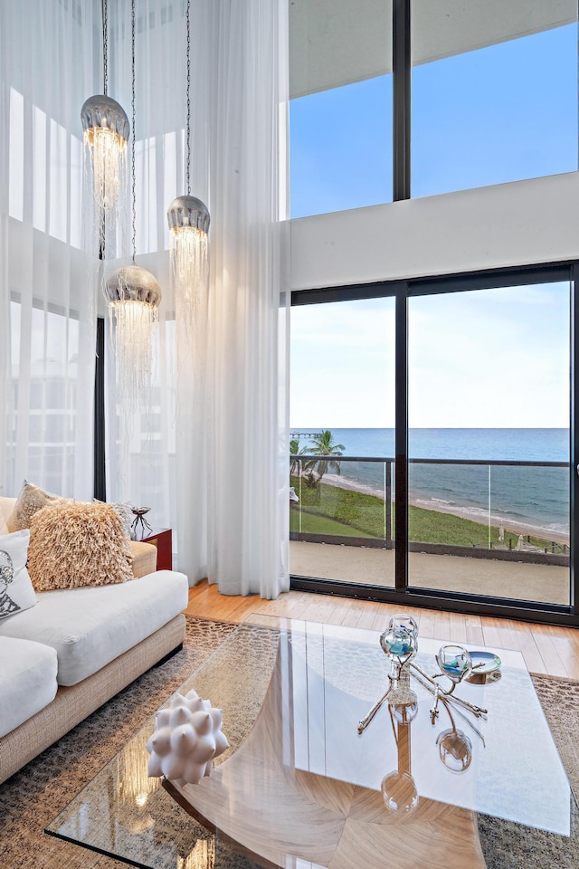 living room featuring a water view, plenty of natural light, and a chandelier