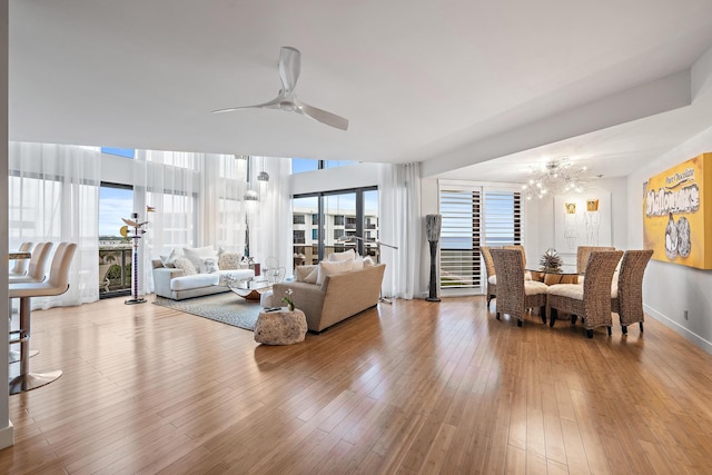 living room featuring ceiling fan and light hardwood / wood-style flooring