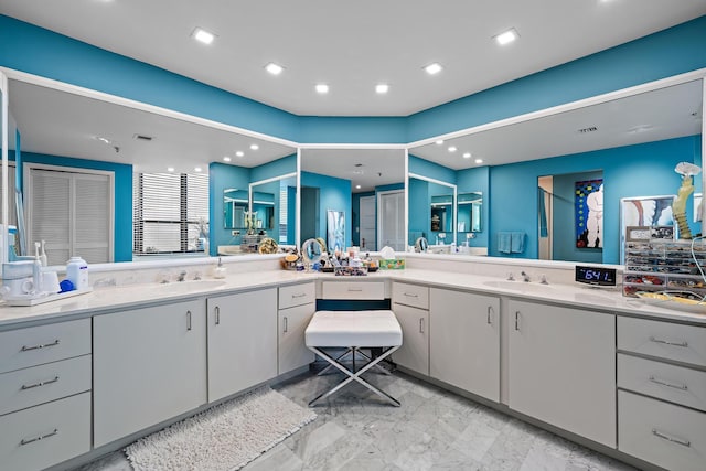 bathroom featuring a shower with shower door and vanity