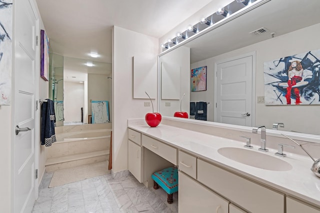 bathroom featuring vanity and a tub