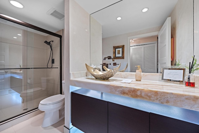 bathroom with a shower with door, toilet, and vanity