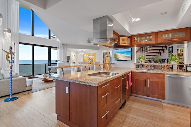 kitchen featuring sink, kitchen peninsula, a water view, stainless steel dishwasher, and black electric cooktop