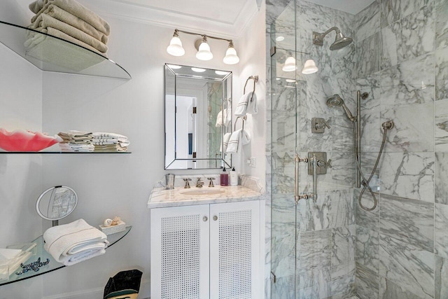 bathroom featuring vanity, a shower with shower door, and ornamental molding