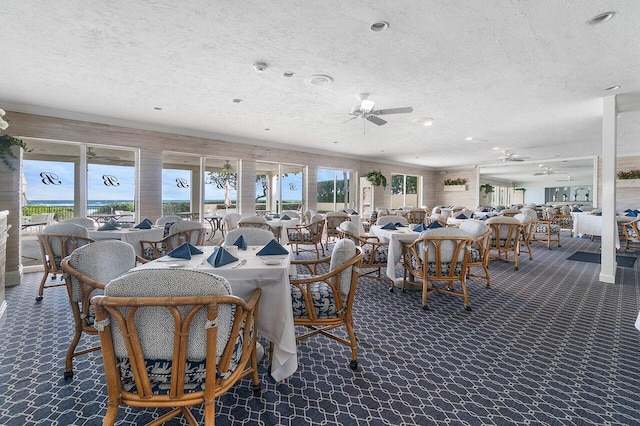 dining space featuring a textured ceiling and ceiling fan