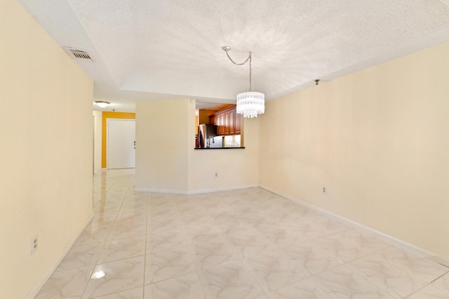 empty room featuring a textured ceiling