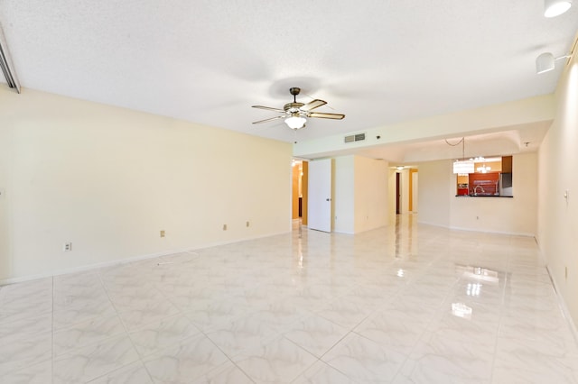 unfurnished room featuring a textured ceiling and ceiling fan