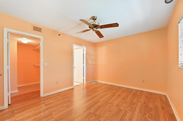 9170 SW 14th St Unit 4107, Boca Raton, FL 33428 - unfurnished bedroom with a textured ceiling, visible vents, a walk in closet, and light wood finished floors