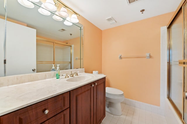 full bathroom featuring tile patterned floors, vanity, toilet, and combined bath / shower with glass door