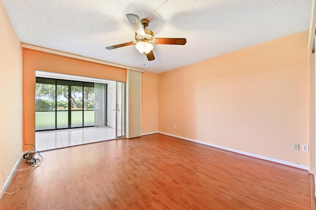 spare room with hardwood / wood-style floors, a textured ceiling, and ceiling fan