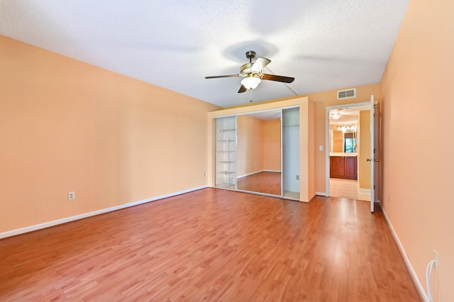 spare room with hardwood / wood-style floors, a textured ceiling, and ceiling fan